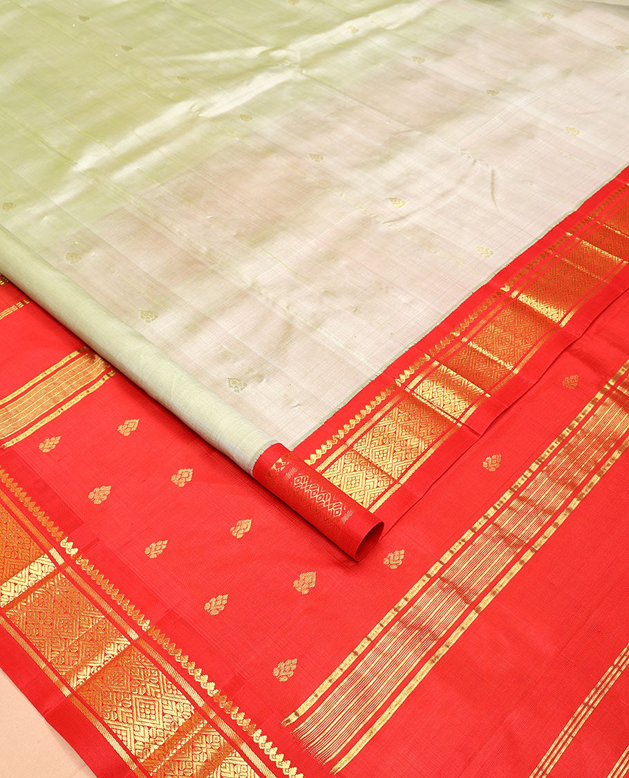 Pale Green Kanchipuram Silk Saree, Mesmerized with Zari Buttas All Over Its Body, Complemented by a Contrast One-Sided Korvai Border of Thilakam Mokku, Banaras, and Jaal Designs, Pallu of Zari Designs, and Comes Without a Blouse