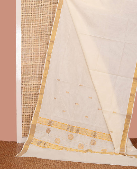 Cream Kerala Saree, Decorated with Zari Buttas on Its Body, Subtly Sparkled Bavanji Border, Pallu Zari  Woven with Floral Designs, and Paired with a Matching Blouse