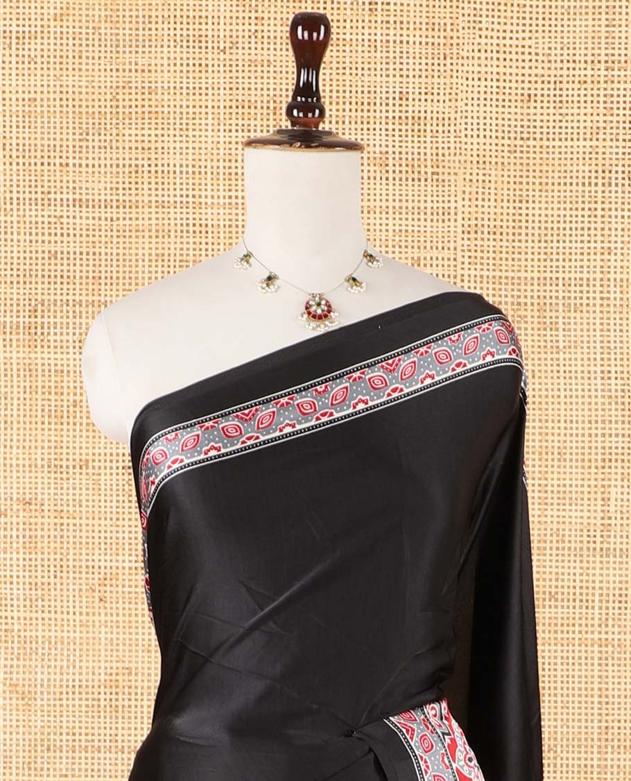 Black half-&-half style modal satin saree features floral & geometric design Ajrakh printed contrast border & pallu