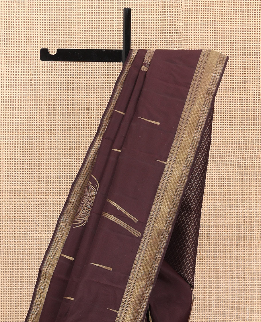 Coffee Brown Vasundhara Silk Saree Decked Up with Thazampoo Rekku Buttas and Vel Buttas, Highlighted with a Zari Border of Manga, Muthu, Kathir, Neli, and Vanki Designs, Subtly Sparkled Pallu of Jaal Design, and Paired with a Matching Blouse
