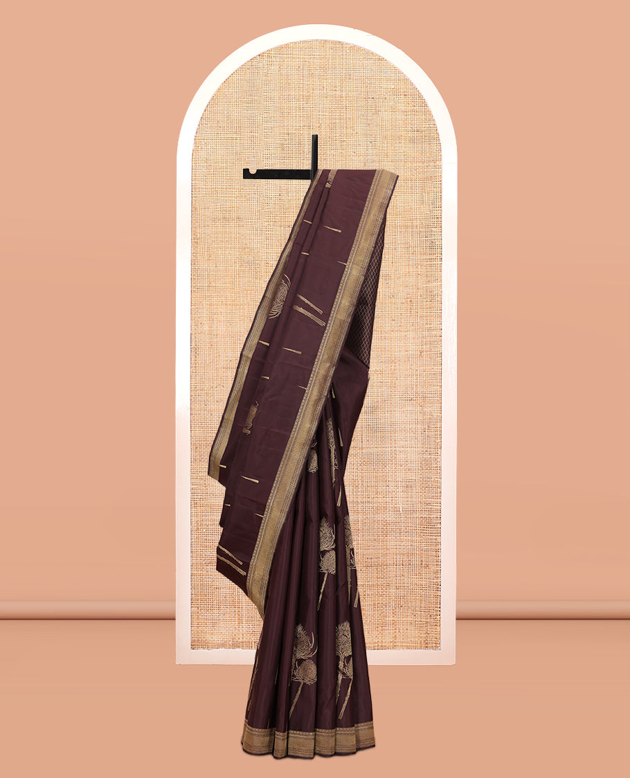 Coffee Brown Vasundhara Silk Saree Decked Up with Thazampoo Rekku Buttas and Vel Buttas, Highlighted with a Zari Border of Manga, Muthu, Kathir, Neli, and Vanki Designs, Subtly Sparkled Pallu of Jaal Design, and Paired with a Matching Blouse