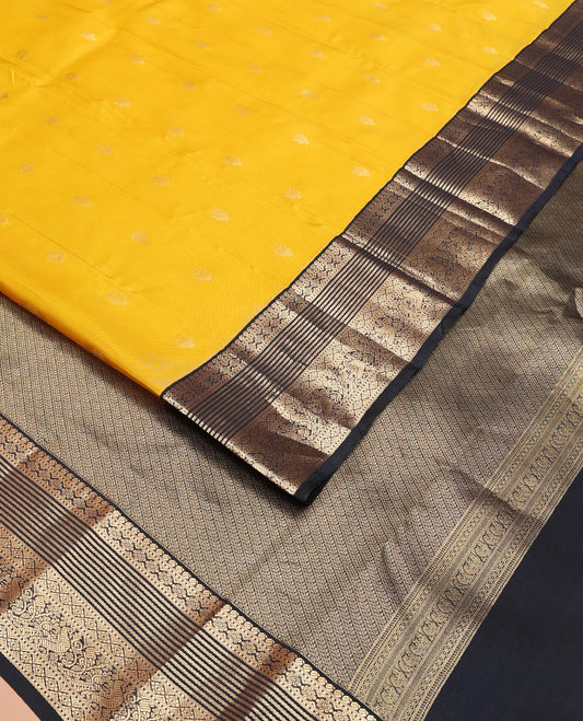Yellow Vasundhara Lite-Silk Mix Saree Decked Up with Zari Buttas, Complemented by a Contrast Black Border Depicting Manga, Muthu, Kamalam, Banaras, Diamond, and Mayil Designs, Pallu Steeped with Diagonal Leaf Vines, and a Contrast Blouse