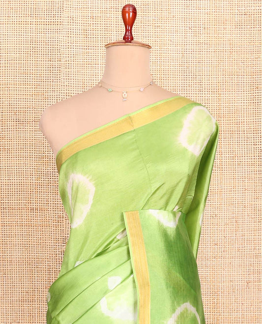 Green Banana Pith Saree Simply Sparkled with Shibori Prints, Zari Bavanji Border, Complemented with a Contrast Printed Pallu of Shibori Motifs, and Paired with a Contrast Blouse