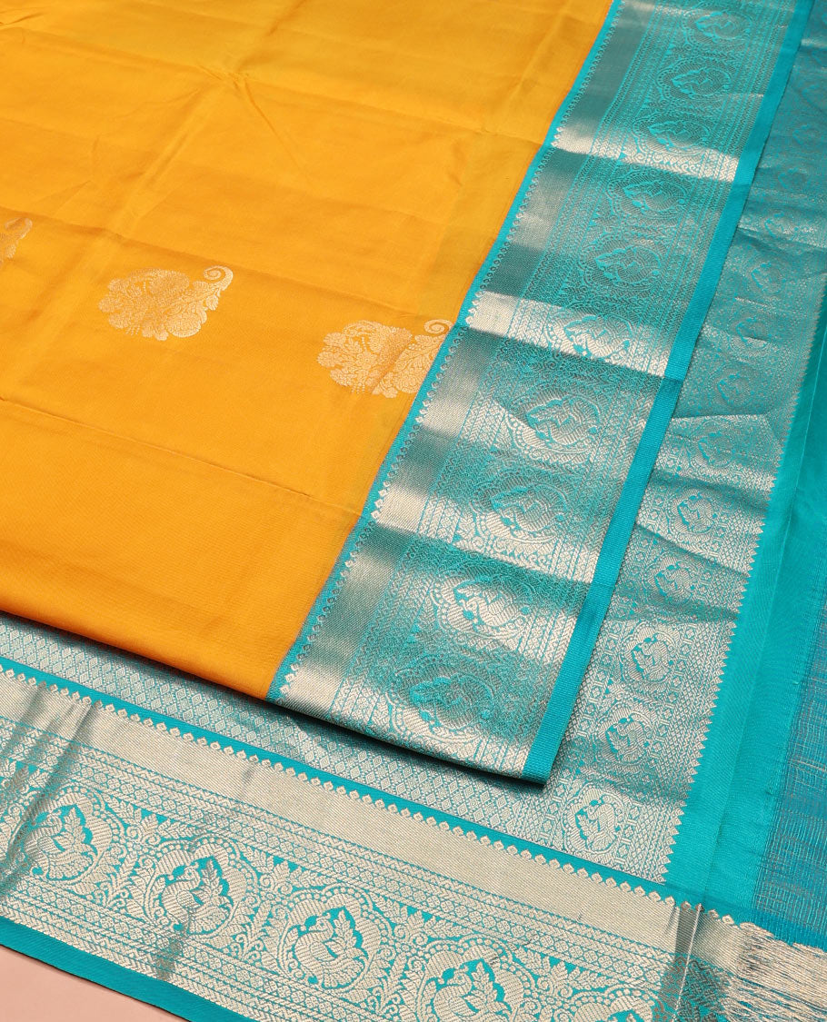 Yellow Vasundhara Silk Saree Ornamented with Zari Buttas All Over Its Body, Complemented by a Contrast Border of Neli, Kathir, Rudraksham, and Mayil Designs, Pallu Featuring Jaal Designs, and Paired with a Contrast Blouse