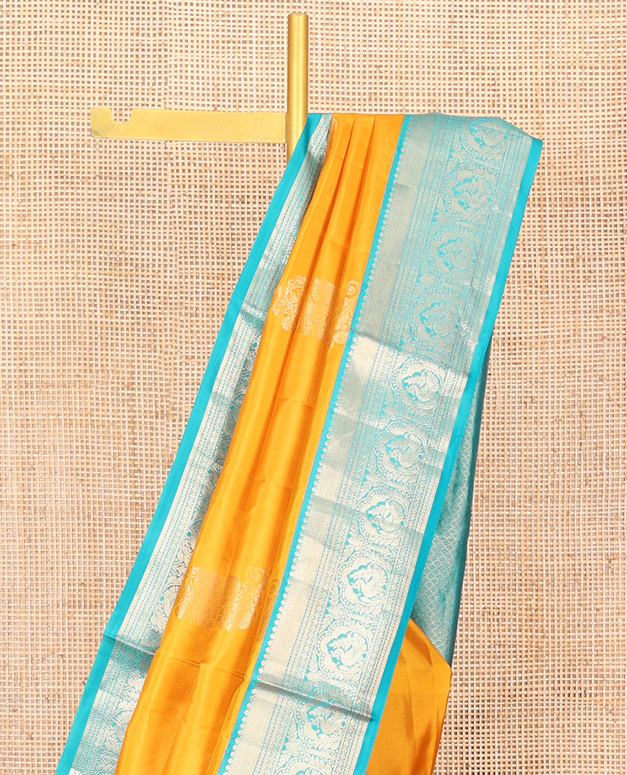 Yellow Vasundhara Silk Saree Ornamented with Zari Buttas All Over Its Body, Complemented by a Contrast Border of Neli, Kathir, Rudraksham, and Mayil Designs, Pallu Featuring Jaal Designs, and Paired with a Contrast Blouse