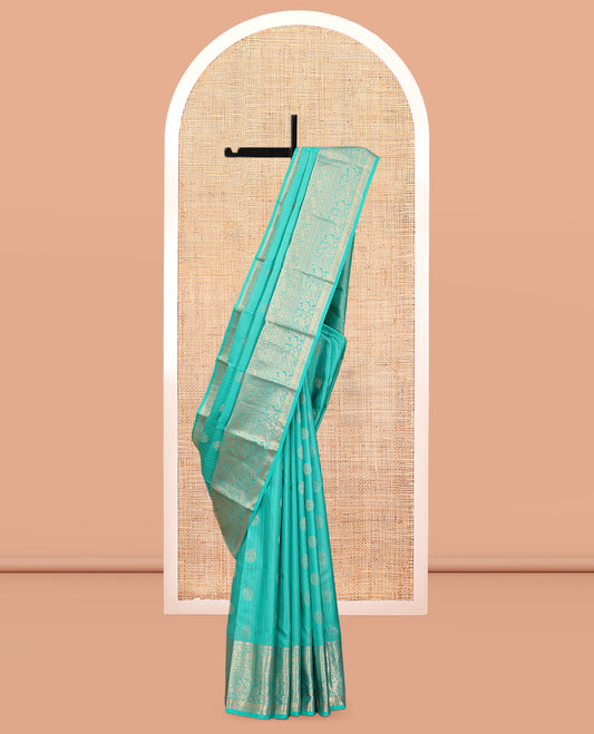 Blue Vasundhara Silk Saree, Accentuated with Zari Buttas and Stripes, a Zari Border of Kathir, Yaanai, Rudraksham, Manga, and Mayil Design, a Grand Pallu, and a Matching Blouse