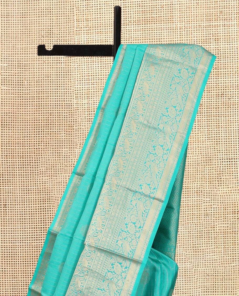 Blue Vasundhara Silk Saree, Accentuated with Zari Buttas and Stripes, a Zari Border of Kathir, Yaanai, Rudraksham, Manga, and Mayil Design, a Grand Pallu, and a Matching Blouse