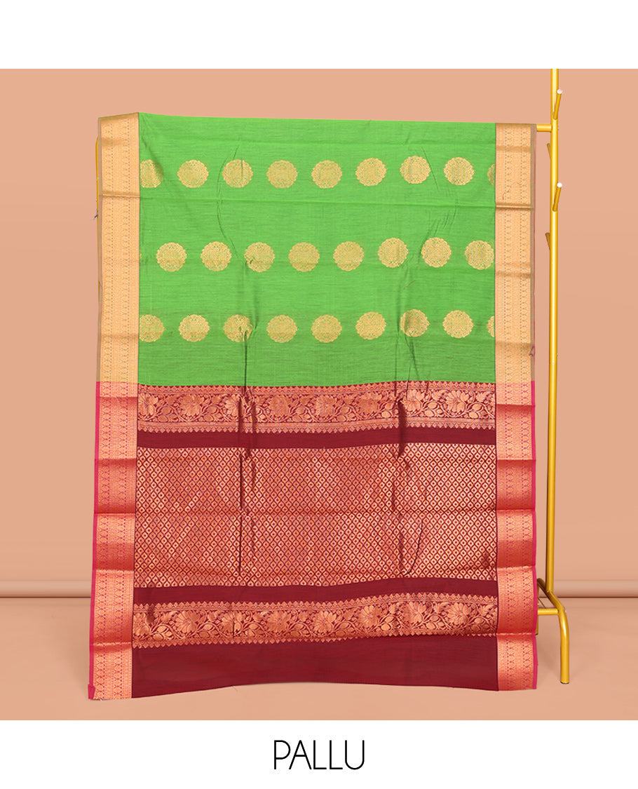 Green Semi-Silk Cotton Saree, Bedecked with Zari Buttas All Over Its Body, Complemented by a Contrast Border of Traditional Zari Designs, Grand Jaal Pallu, and Paired with a Contrast Blouse