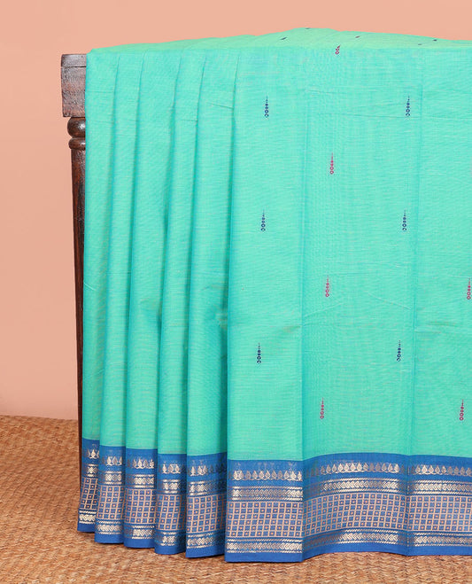 Turquoise Chettinad Cotton Saree Subtly Woven with Thread Buttas on Its Body, Complemented by a Contrast Traditional Design Woven Zari Border, Subtly Striped Pallu, and Paired with a Matching Blouse
