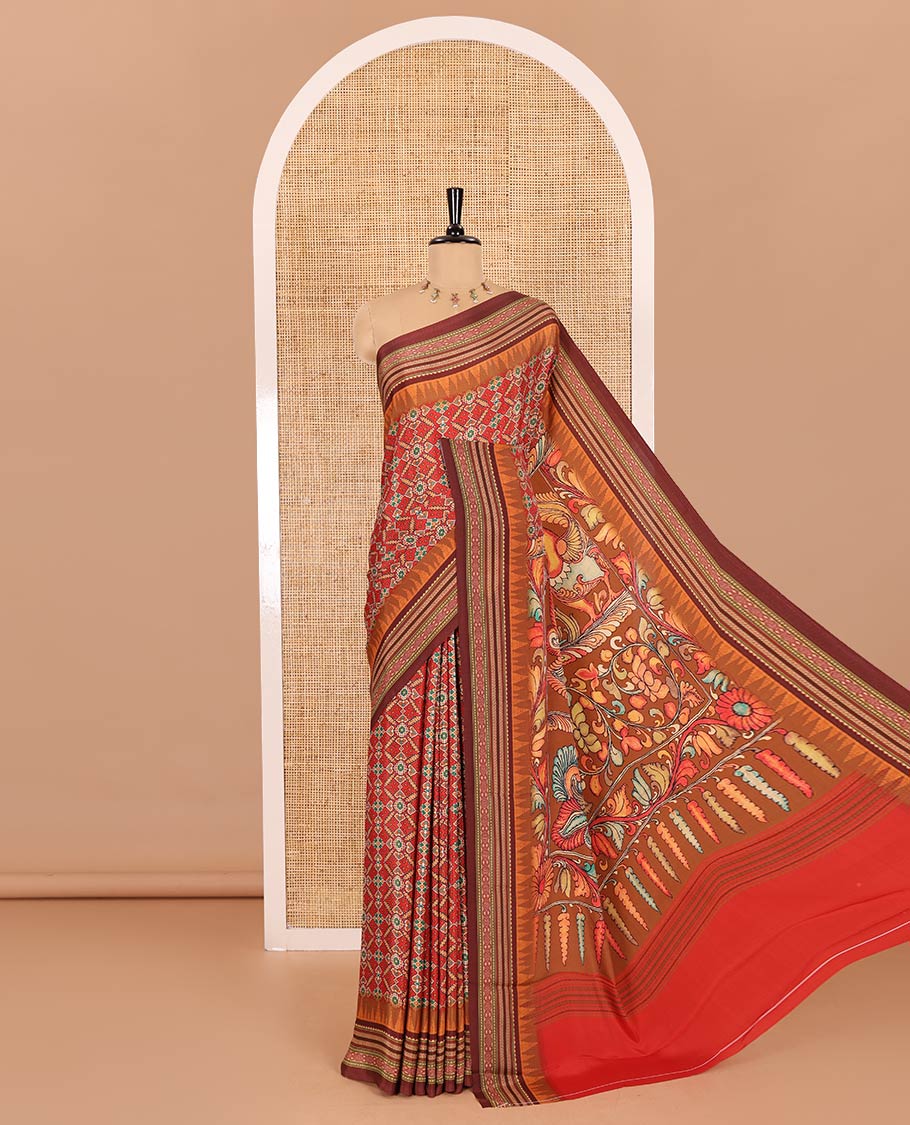 Tomato red patola style geometric printed Italian Crepe saree, contrast temple ikkat printed border, Kalamkari printed pallu, and a printed bordered blouse