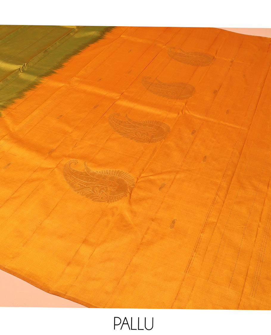 Green Kanchipuram Silk Saree, Sparsely Woven with Buttas All Over Its Body, Complemented by a Contrast Border of Thilakam Designs, Pallu Features Manga Zari Designs, and Paired with a Contrast Blouse