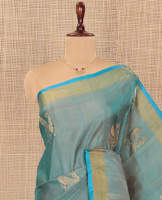 Blue Uppada Silk Saree Accentuated with Parrot Zari Buttas, Complemented by Bavanji Border, Contrast Pallu Steeped with Parrot Zari Designs, and Paired with a Contrast Blouse