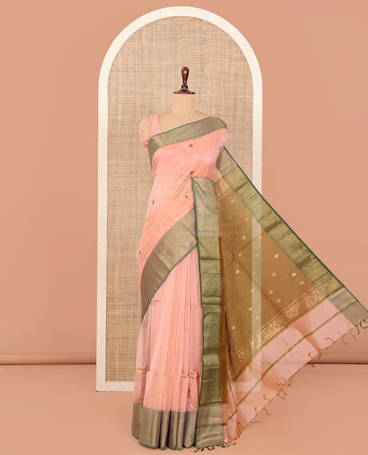 Peach Maheshwari Cotton Saree, Masterfully Woven with Thread Buttas All Over Its Body, Complemented by Contrast Traditional Zari Design Border, Pallu Steeped with Flower Buttas, and Paired with a Contrast Blouse