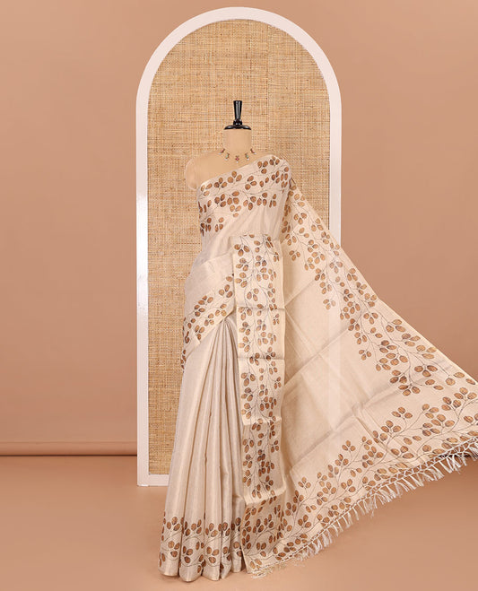 Cream plain body tissue saree with leaf vine printed border, printed pallu, and a contrast plain blouse