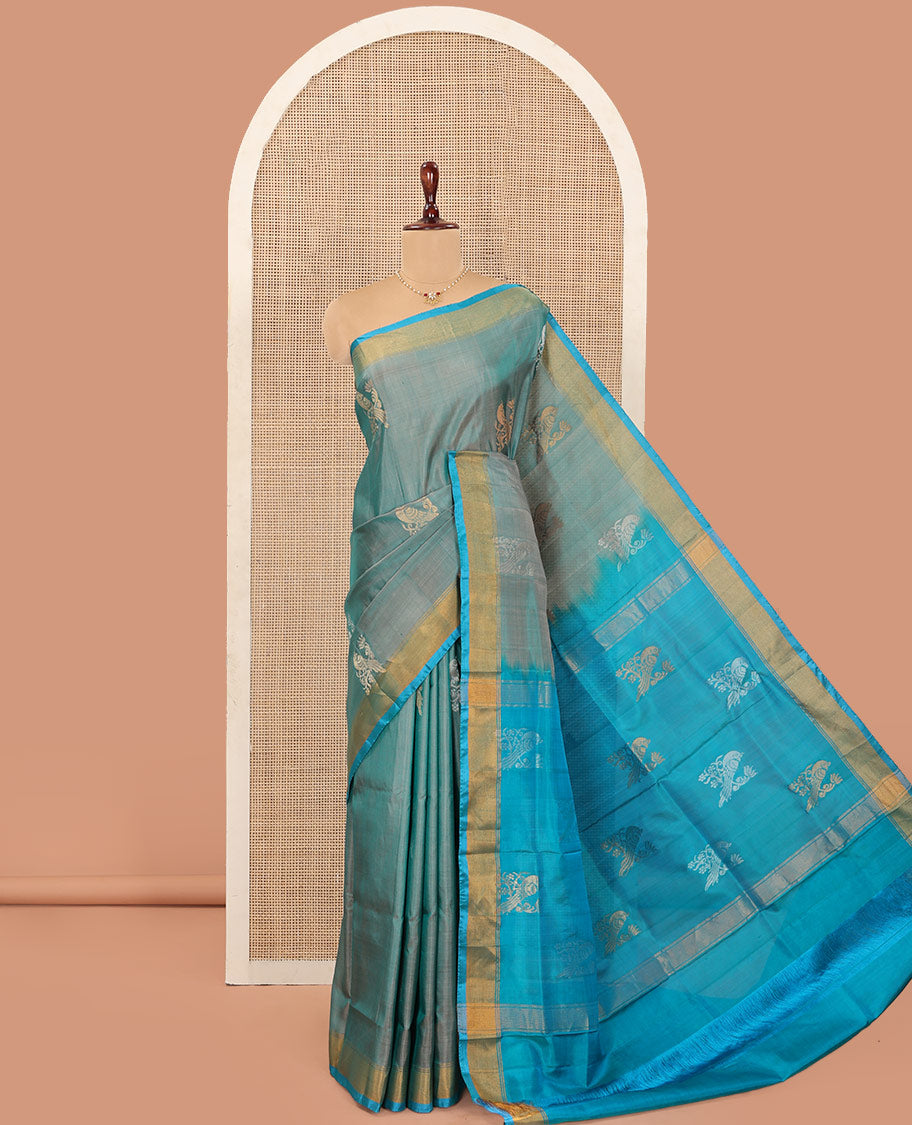 Blue Uppada Silk Saree Accentuated with Parrot Zari Buttas, Complemented by Bavanji Border, Contrast Pallu Steeped with Parrot Zari Designs, and Paired with a Contrast Blouse