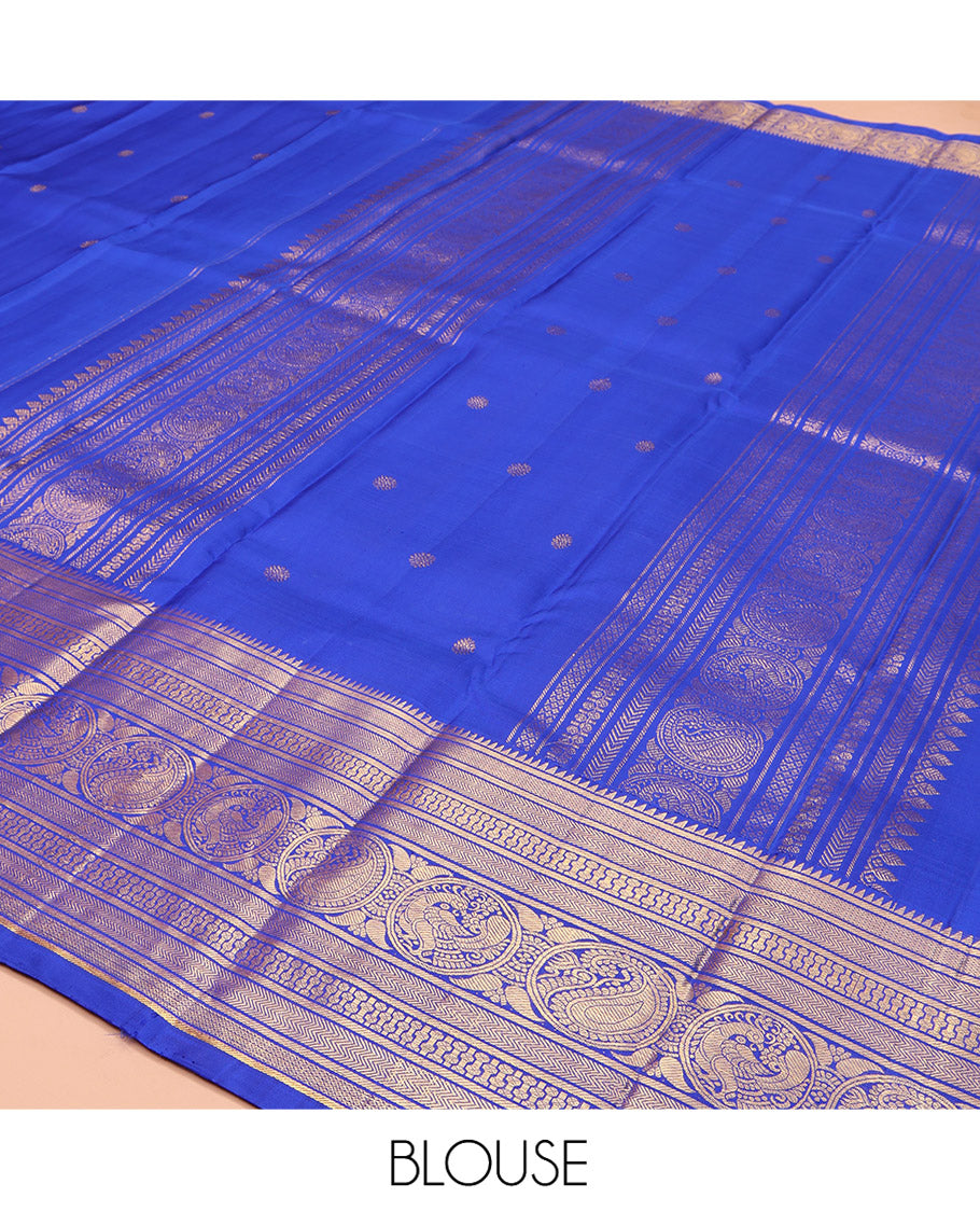 Blue Kanchipuram Silk Saree, Bedecked with Zari Buttas All Over Its Body, Highlighted by a Zari Border of Rekku, Vanki, Round Mayil, and Poun Manga Designs, Pallu of Zari Designs, and Paired with a Matching Blouse