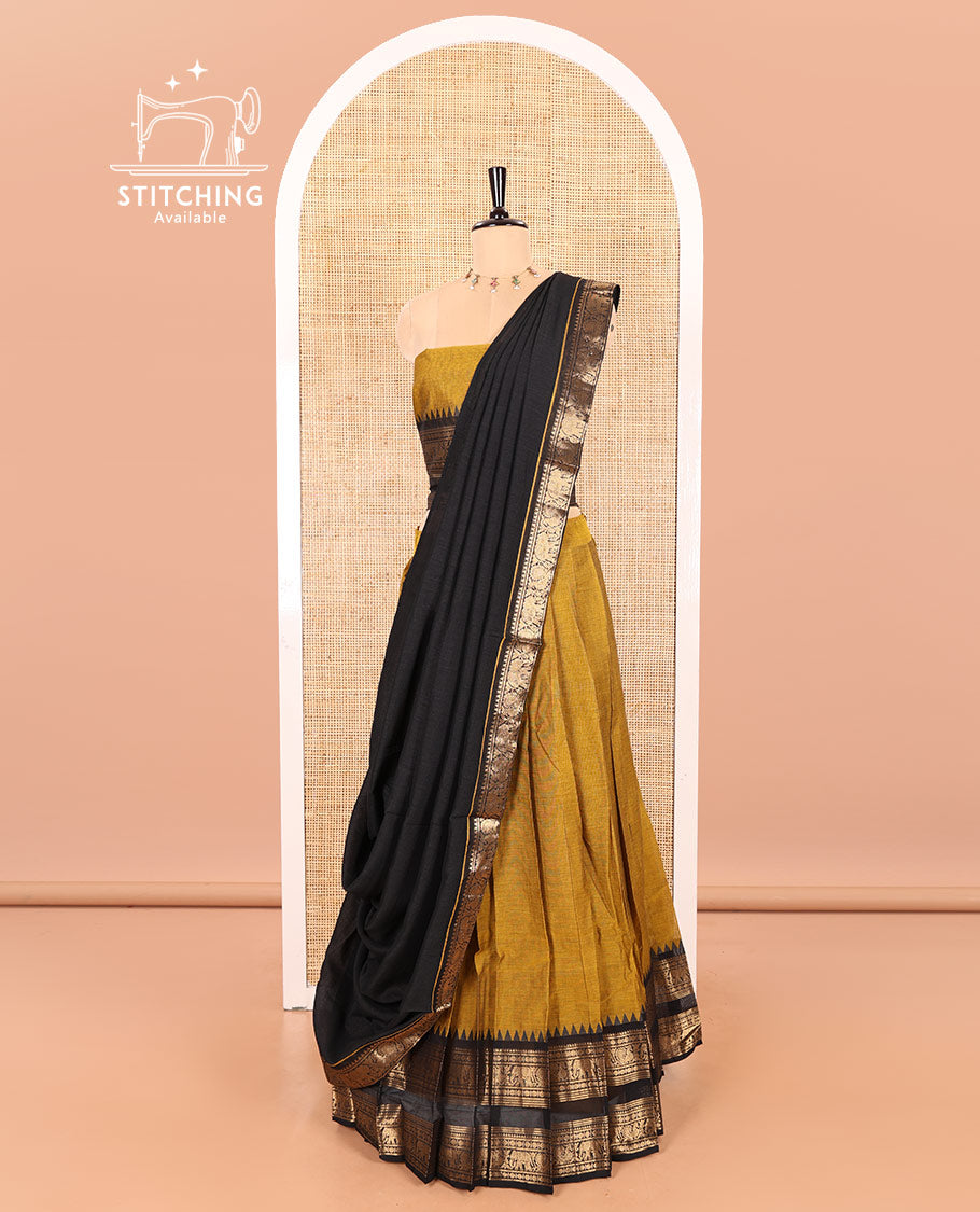 Mustard-Black Chettinad Cotton Half-Saree Featuring a Plain Skirt, Highlighted with a Contrast Peacock-Elephant Motifs Woven Rettai Pettu Zari Border, a Subtly Woven Matching Blouse, and a Vichitra Silk Contrast Traditional Zari-Bordered Dhavani
