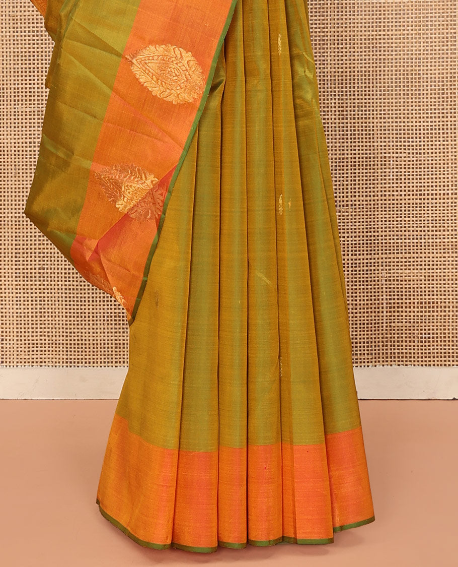 Green Kanchipuram Silk Saree, Sparsely Woven with Buttas All Over Its Body, Complemented by a Contrast Border of Thilakam Designs, Pallu Features Manga Zari Designs, and Paired with a Contrast Blouse