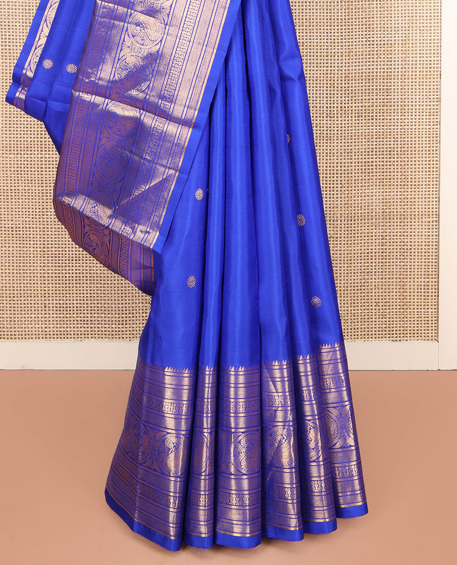 Blue Kanchipuram Silk Saree, Bedecked with Zari Buttas All Over Its Body, Highlighted by a Zari Border of Rekku, Vanki, Round Mayil, and Poun Manga Designs, Pallu of Zari Designs, and Paired with a Matching Blouse