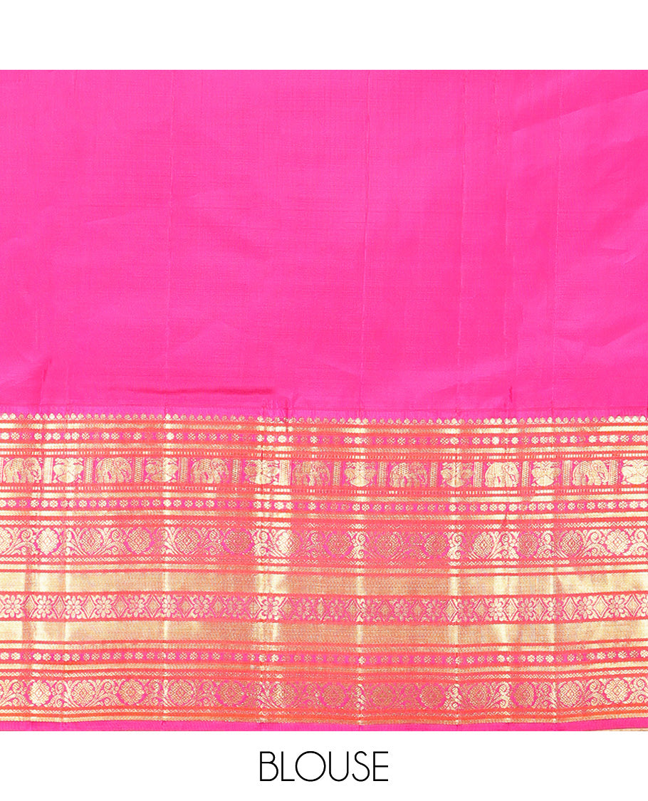 Green Vasundhara Silk Saree, Delicately Woven with Zari Buttas All Over Its Body, Complemented by Contrast Border of Thilakam Mokku, Kamalam, Iruthalai Pakshi, Yaanai, and Kamalam Designs, Vanki Design Pallu and Paired with a Contrast Blouse