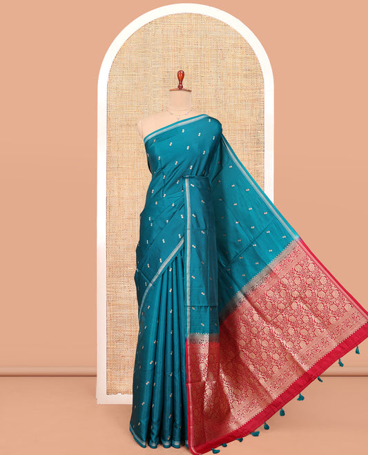 Peacock Blue Satin Silk Saree, Enthralled with Buttas All Over Its Body, a Subtle Piping Border, Complemented by a Contrast Pallu of Floral-Paisley Designs in Zari, and Paired with a Contrast Blouse