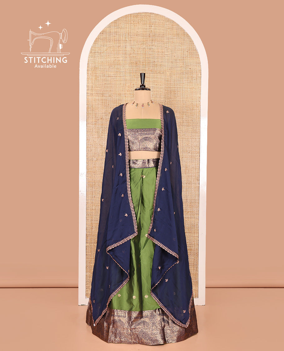 Leaf Green and Blue Semi-Banarasi Half-Saree, Beautifully Woven with Zari Buttas on Its Skirt, Complemented by a Contrast Geometric Patterns Zari Woven Border, Paired with a Matching Blouse, and a Contrast Satin Georgette Embroidered Scallop Dhavani