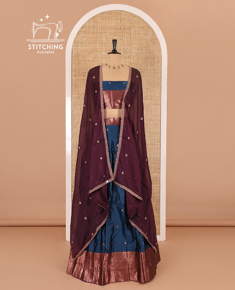 Blue taffeta silk half-saree, zari buttas with contrast traditional zari bordered skirt, matching zari design blouse, and contrast scallop buttas embroidered dhavani