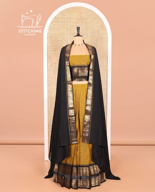 Mustard-Black Chettinad Cotton Half-Saree Featuring a Plain Skirt, Highlighted with a Contrast Peacock-Elephant Motifs Woven Rettai Pettu Zari Border, a Subtly Woven Matching Blouse, and a Vichitra Silk Contrast Traditional Zari-Bordered Dhavani