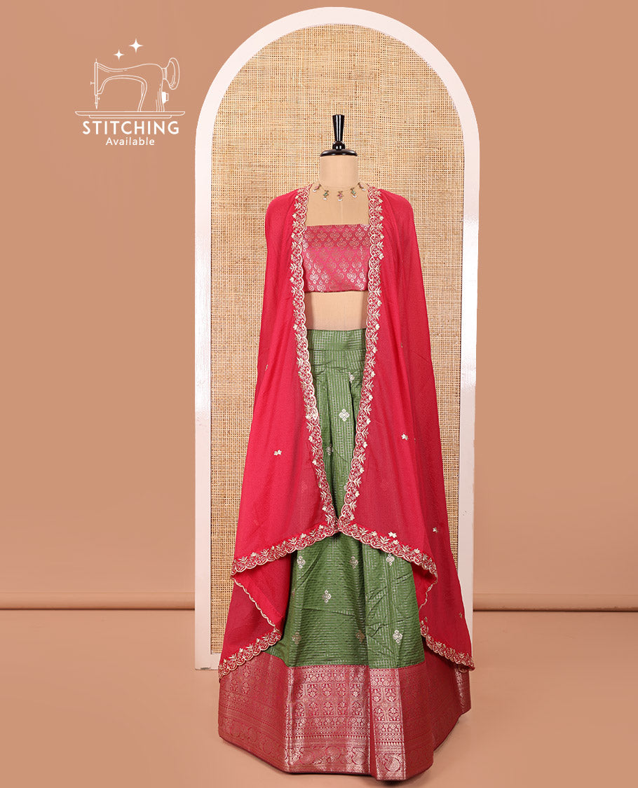Green and Red Banaras Silk Half-Saree Featuring Zari Checks and Zari Buttas All Over the Skirt, Complemented by Contrast Traditional Zari Design Border, Paired with a Jacquard Blouse, and a Rangoli Georgette Dhavani of Embroidery and Scallop Border