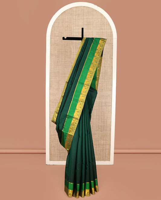 Green Kanchipuram Silk Saree, Sparsely Woven with Vazhaipoo Stripes on Its Body, Complemented by Contrast Rettai Pettu Border of Salngai, and Yaanai Designs, Zari-Striped Pallu, and Paired with a Contrast Blouse