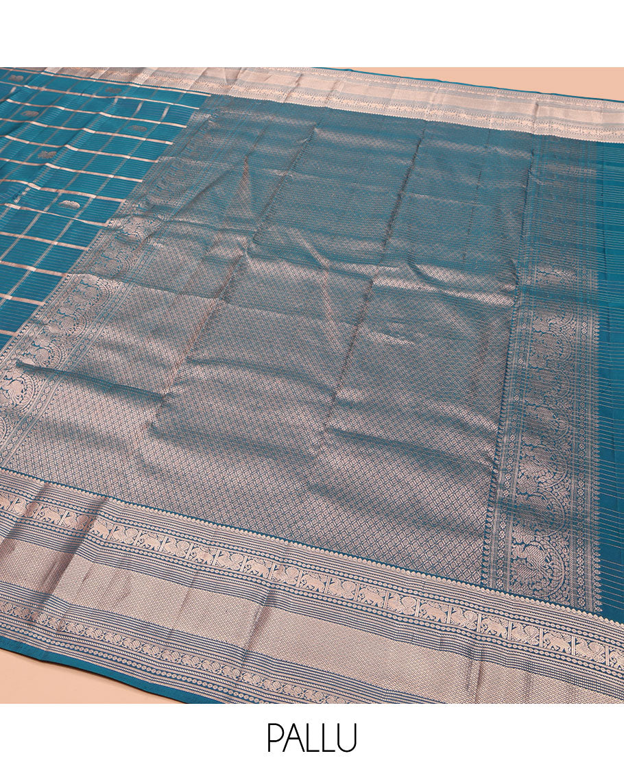 Blue Vasundhara Silk Saree, Enriched with Zari Butta Enclosed Checked Design All Over Its Body, Highlighted by Zari Border of Thilakam Mokku, Muthu, Mayil, Yaanai, and Mayil Kann Designs, Grand Jaal Pallu, and Paired with a Matching Blouse