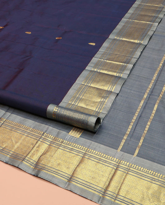 Navy Blue Kanchipuram Silk Saree, Beautified with Zari Buttas on Its Body, Complemented by a Contrast One-Sided Border of Paneer Sombu, Banaras, Muthu and Jaal Designs, Pallu of Zari Designs, and Comes Without a Blouse