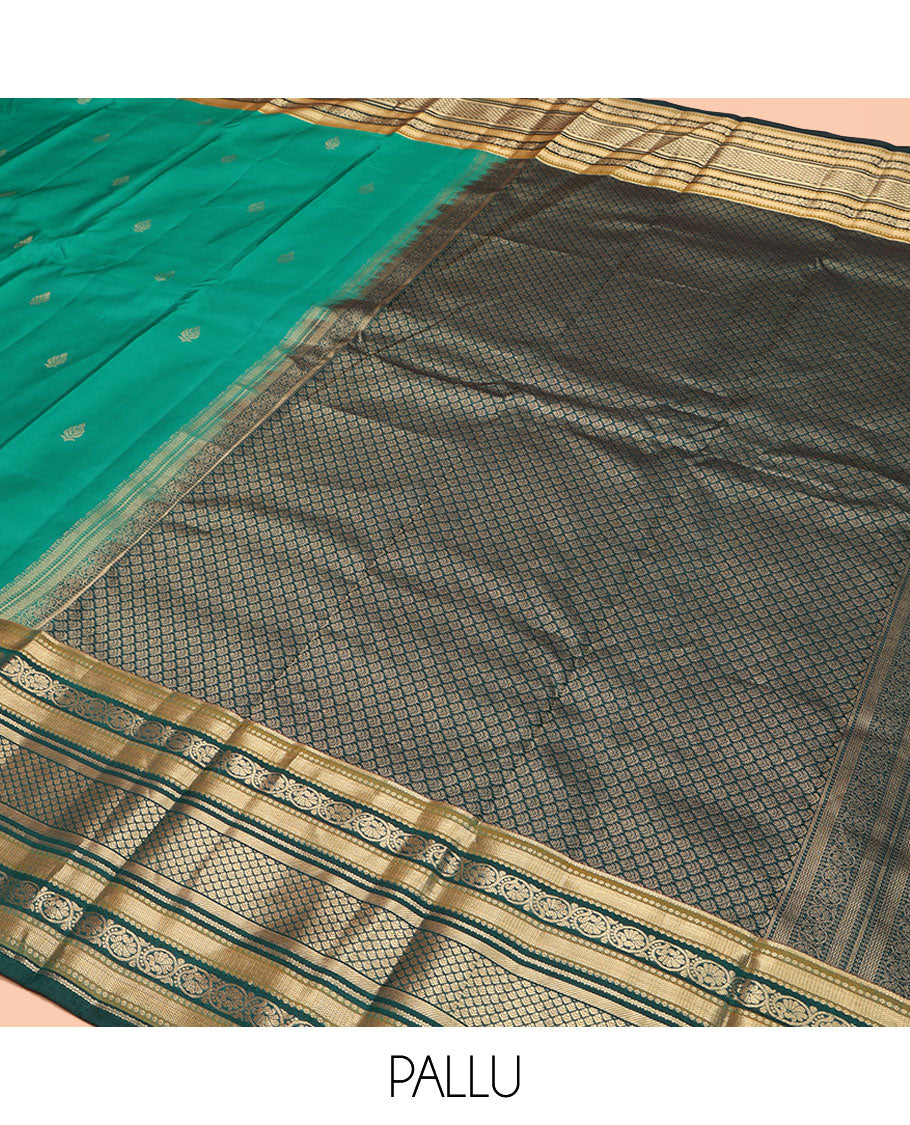 Green Kanchipuram Silk Saree, Detailed with Buttas on Its Body, Complemented by a Contrast Border of Vanki, Kodi Visiry, Neli, Banaras, and Jaal Designs, Grandly Jaal Woven Pallu, and Paired with a Contrast Blouse