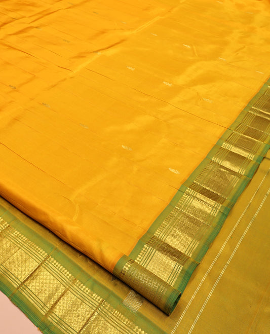 Yellow Kanchipuram Silk Saree Features Buttas, a Contrast One-Sided Border of Panner Sombu, Banaras, Muthu, and Mayil Kann Designs, Zari Design Pallu, and No Blouse