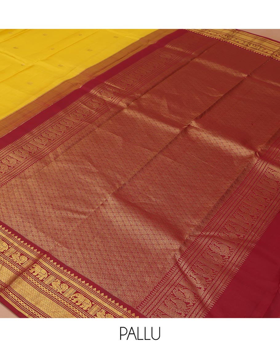 Yellow Vasundhara Silk Saree, Subtly Sparkled with Buttas All Over Its Body, Complemented by a Contrast Border of Thilakam, Neli, Kathir, Mayil, Yaanai, and Mayil Kann Designs, Grand Jaal Pallu, and Paired with a Contrast Blouse