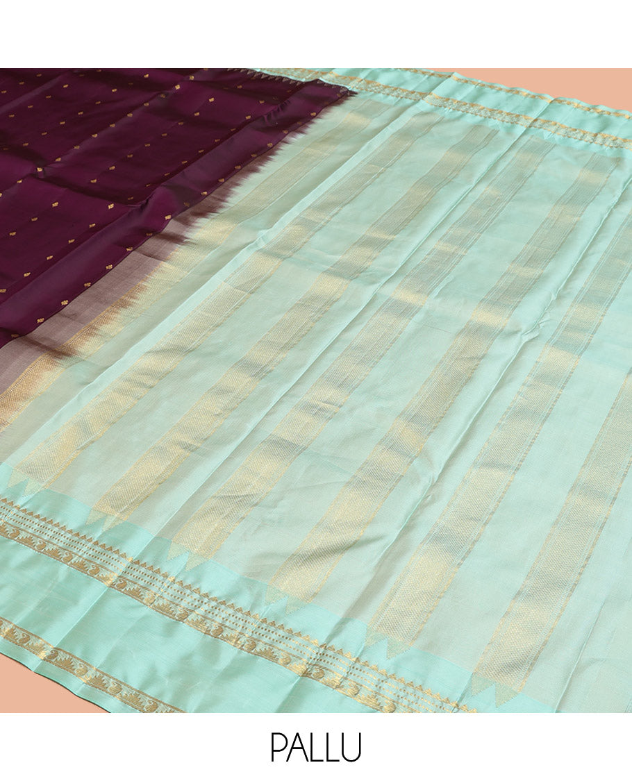 Purple Vasundhara Silk Saree, Spotlighted With Zari Buttas All Across Its Body, Complemented by Captivating Contrast Rettai Pettu Border of Thazampoo Rekku, Muthu, And Manga Designs, a Gleaming Zari Design Pallu, And Paired With a Contrast Blouse