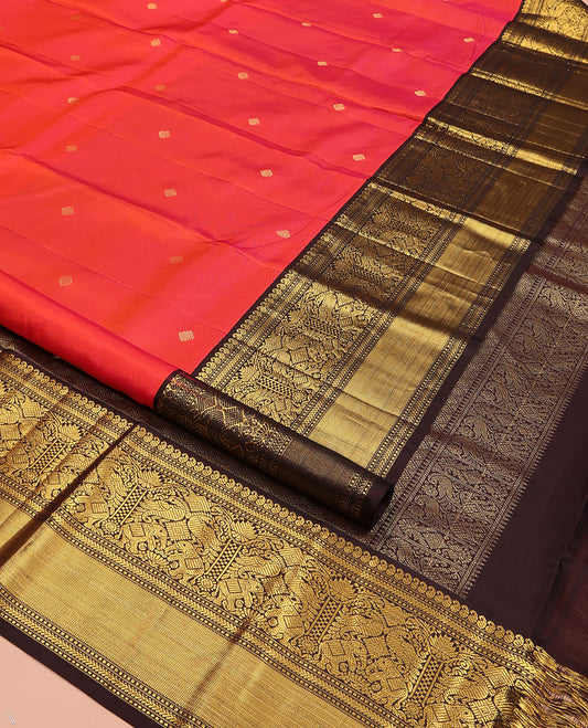Coral Vasundhara Silk Saree, Elevated with Zari Buttas All Over Its Body, Complemented by a Contrast Border of Manga, Muthu, Kathir, Mayil, and Yaanai Designs, Grand Jaal Pallu, and Paired with a Contrast Blouse