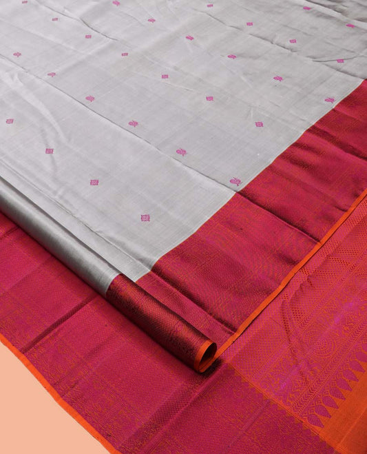 Grey Kanchipuram Silk Saree, Subtly Sparkled with Mayil-Chakram Buttas, a Contrast Border of Thilakam Mokku, Iruthalai Pakshi, and Kuyil Kann, Jaal Pallu, and a Contrast Blouse