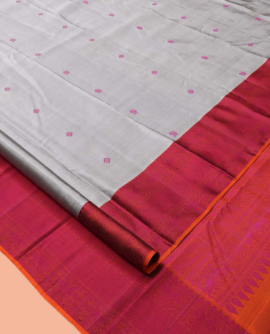 Grey Kanchipuram Silk Saree, Subtly Sparkled with Mayil-Chakram Buttas, a Contrast Border of Thilakam Mokku, Iruthalai Pakshi, and Kuyil Kann, Jaal Pallu, and a Contrast Blouse