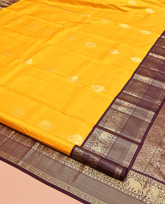Yellow Vasundhara Silk Saree, Richly Detailed with Zari Buttas, Contrast Border of Thilakam Mokku, Mayil Kann, Yaali, Yaanai, Mayil, and Kodi Visiry, Grand Pallu, and a Contrast Blouse