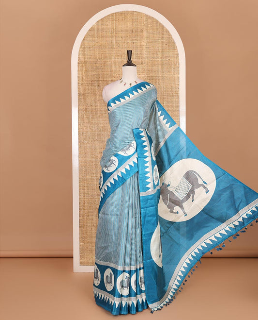 Cream-blue vertically striped khadi cotton saree, contrast Pichwai cow printed temple border, Pichwai cow print pallu, and jaal printed blouse