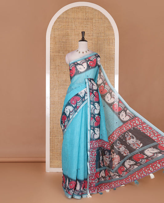 Blue mirror thread embroidered linen saree, contrast kalamkari peacock printed border, pallu of kalamkari peacock and human figurines print, and printed blouse
