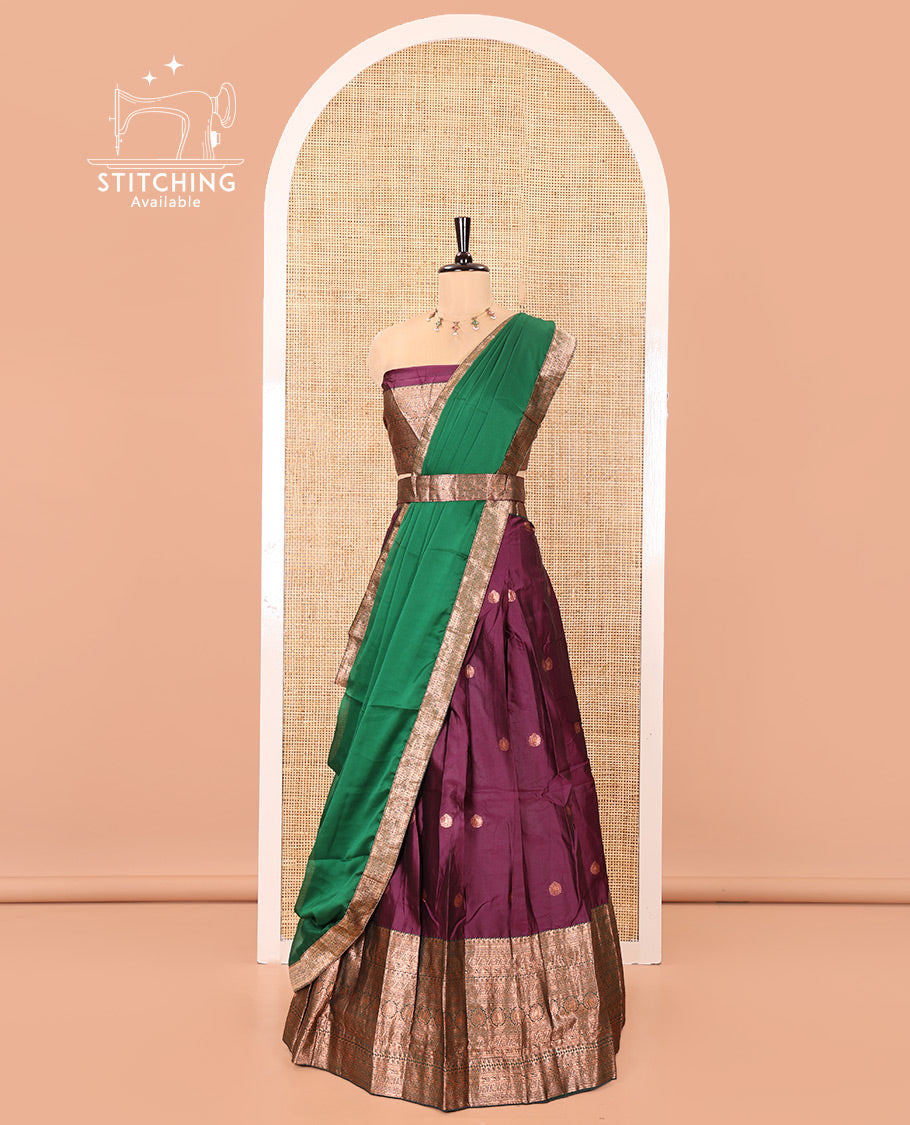 Purple and Green Semi-Banarasi Half-Saree, Elevated with Zari Buttas on Its Skirt, Complemented by a Contrast Traditional Zari-Design Border, Paired with a Matching Blouse, and a Contrast Satin Georgette Zari-Bordered Dhavani