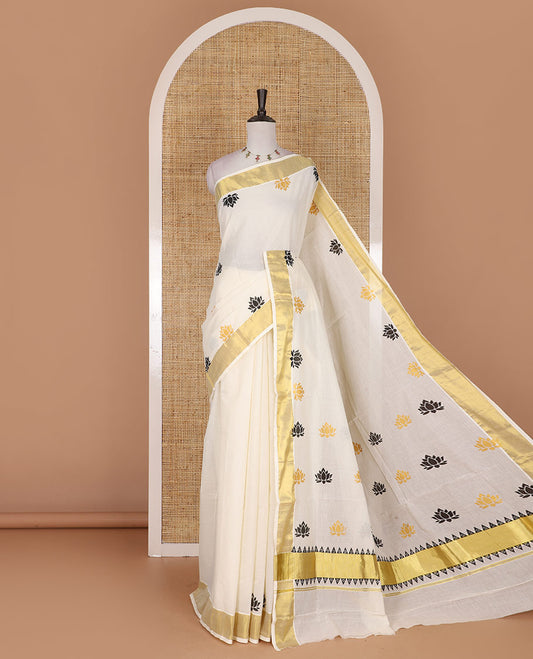 Half-white lotus motifs printed Kerala cotton saree, gold zari border, lotus motifs printed pallu, and matching blouse
