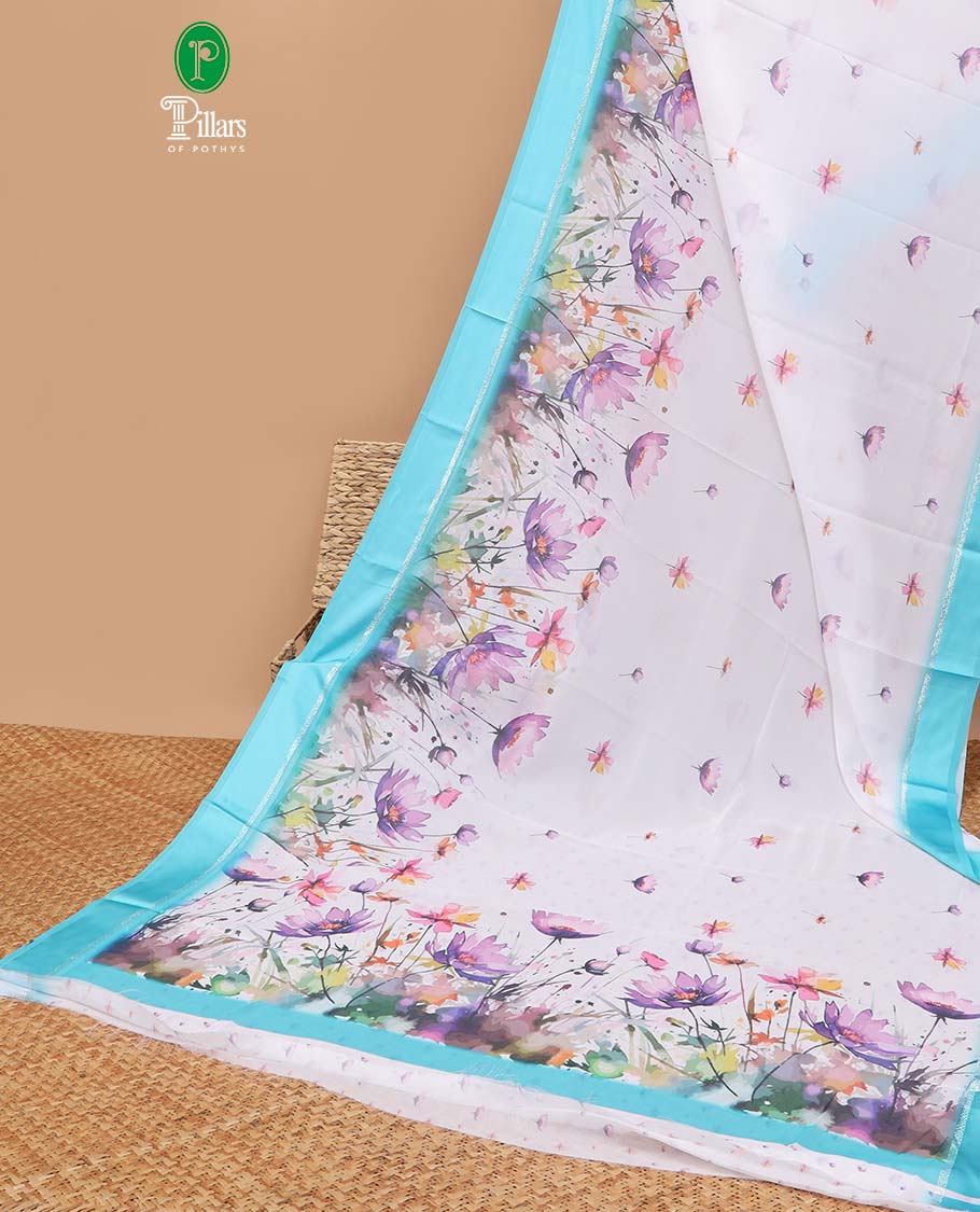 White digital floral design moss chiffon saree with contrast blue zari border & floral design pallu