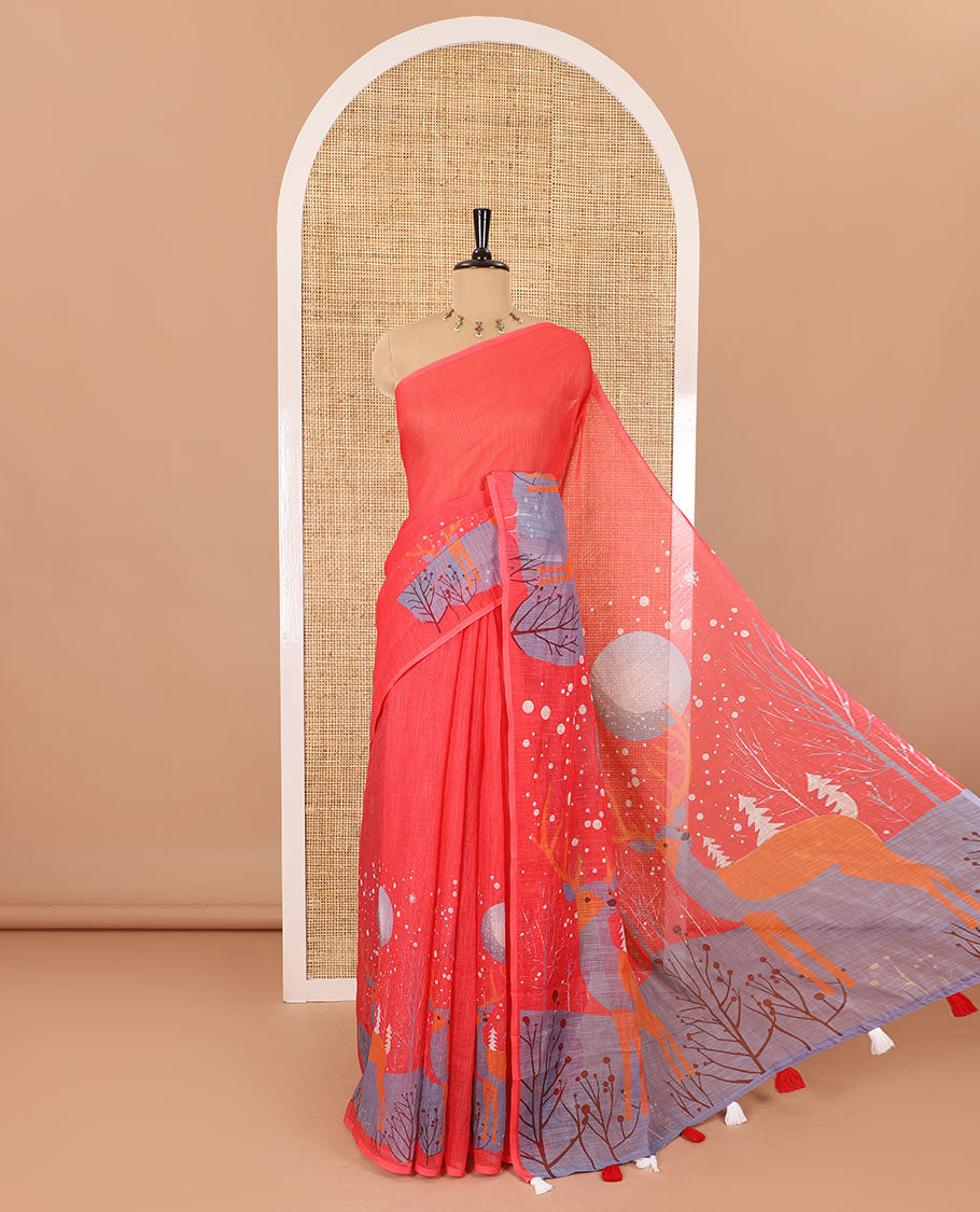 Borderless tomato pink Christmas-theme Snow-fall, moon, Christmas trees, and deer motifs printed linen cotton saree with a contrast printed blouse