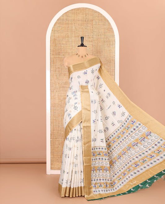 Half-white buttas with warli village motifs printed dola silk saree, contrast traditional zari border of paisleys, warli printed pallu, and a contrast printed blouse