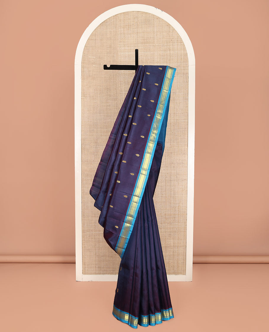Navy Blue Kanchipuram Silk Saree, Beautifully Bedecked with Zari Buttas on Its Body, Complemented by Contrast One-Sided Border of Banaras, and Jaal Designs, Pallu Features Zari Designs, and Comes Without a Blouse