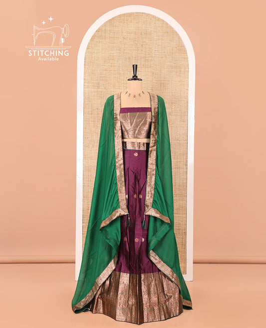 Purple and Green Semi-Banarasi Half-Saree, Elevated with Zari Buttas on Its Skirt, Complemented by a Contrast Traditional Zari-Design Border, Paired with a Matching Blouse, and a Contrast Satin Georgette Zari-Bordered Dhavani
