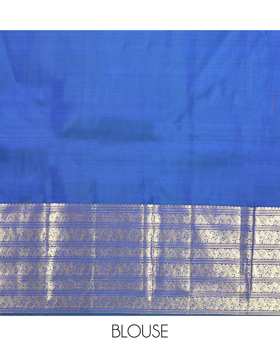 Blue Kanchipuram Silk Saree, Decorated with Zari Buttas All Over Its Body, Highlighted by a Zari Border of Salngai, Muthu, Mayil, and Kuthirai Designs, Grand Jaal Pallu, and Paired with a Matching Blouse